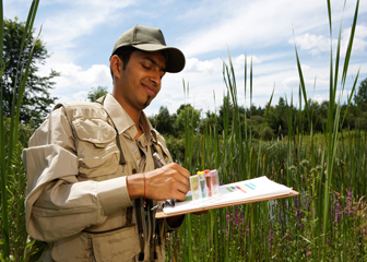 Researcher testing water quality of wetland